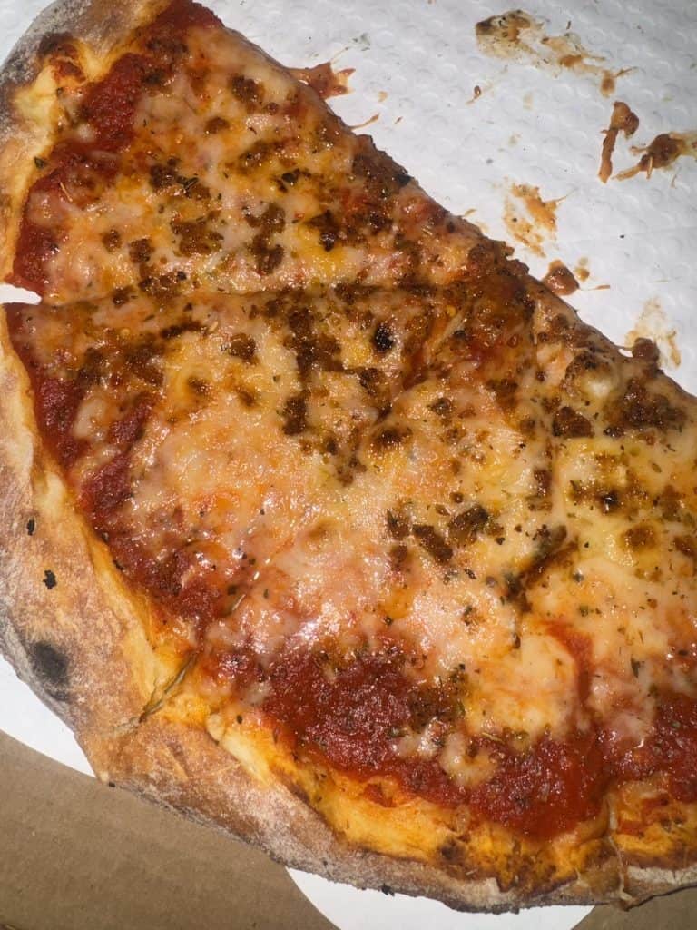 Vegan pizza at P.A.R.M Italia with plant-based sausage and dairy-free cheese